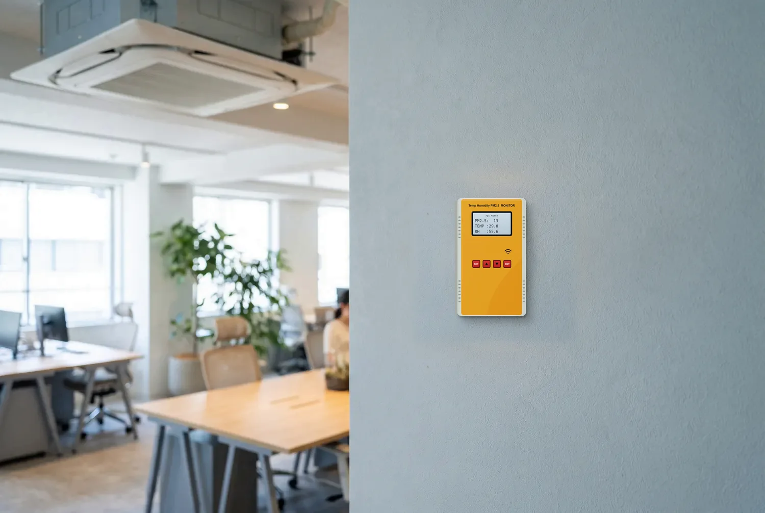 Illustration: the AirDoot air monitor (temperature, humidity and PM2.5, with a backlit screen and Wi-Fi) on an office wall near a cassette AC